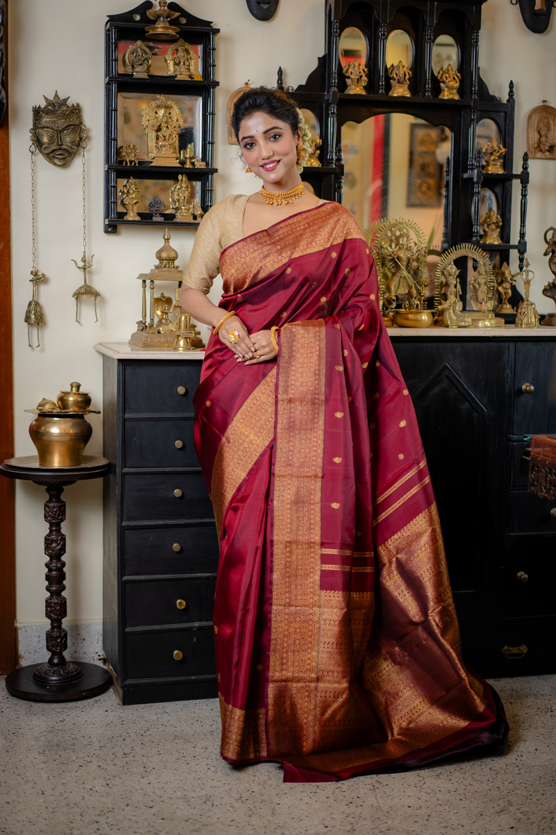 Majestic Rich Maroon Fabric Adorned with an Exquisite Gold Bordered Handwoven Kanjivaram Saree